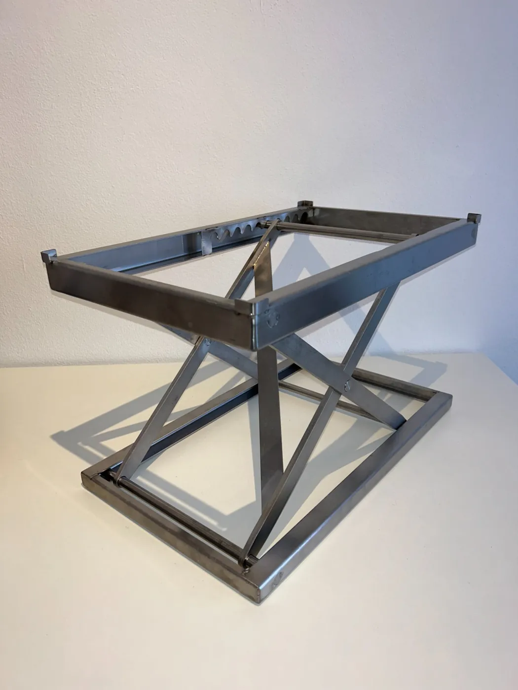 ErgoCutter stainless steel cutting board riser, front view